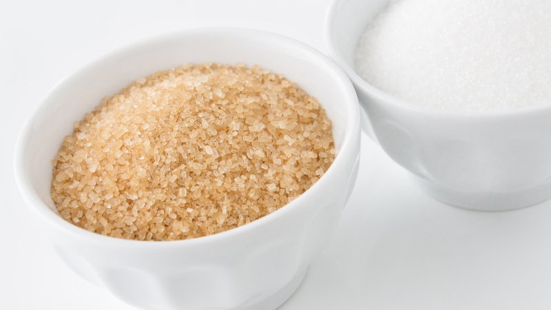 Two bowls showing maple sugar and white sugar side by side