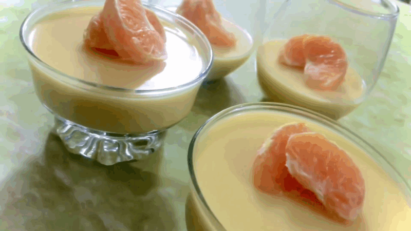 Creamy orange and maple panna cotta topped with fresh mandarin slices, served in glass dishes